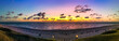 The beach of Westerland on the island of Sylt, Germany. Panoramic view at sundown with spectacular evening sky colors.