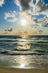 Wall Mural - The beach of Westerland on the island of Sylt, Germany. In the evening the sunlight is reflecting off the sea.