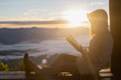 © Tinnakorn - Woman holding reading Bible on Mountain in the Morning- Image