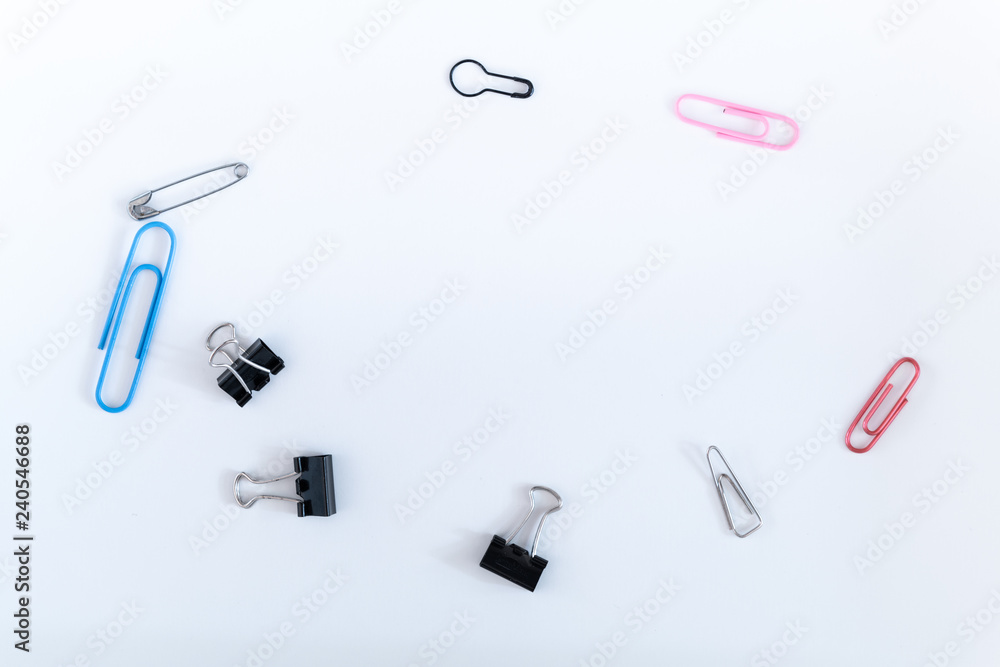 Different kinds of paper clips on white background. Illustration of ...