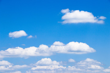 White fluffy clouds in the blue sky.