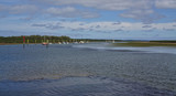 Fototapeta Na sufit - Distant view of moored boats on peaceful water