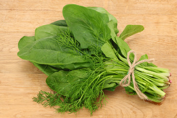 spinach leaves on wooden background. Healthy food. Top view.