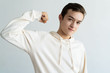 © Mangostar - Content teen boy pumping fist and showing strength. Handsome young guy demonstrating power and looking at camera. Power concept. Isolated front view on white background.