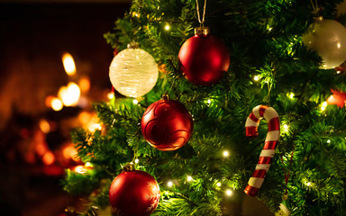 christmas tree close up on blurred burning fireplace background