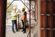 © Diego Cervo - Portrait Of Happy Construction Site Supervisor Talking To Manual Worker