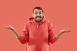 © master1305 - Wow. Attractive male half-length front portrait on coral studio backgroud. Young emotional surprised bearded man standing with open mouth. Human emotions, facial expression concept. Trendy colors