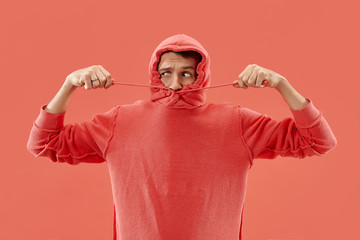 Wall Mural - I'm afraid. Fright. Portrait of the scared man. Business man standing isolated on trendy coral studio background. male half-length portrait. Human emotions, facial expression concept