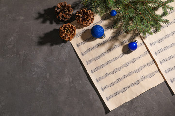 Sticker - Composition with Christmas balls and music sheets on grey background, top view. Space for text