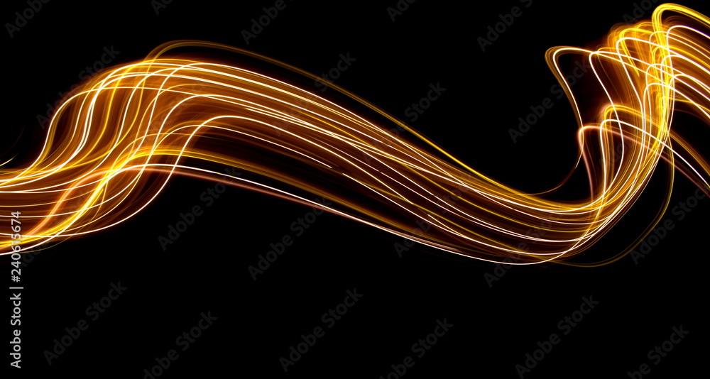 Long exposure light painting photography, curvy lines of vibrant neon metallic yellow gold against a black background - obrazy, fototapety, plakaty 