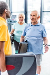 Wall Mural - male senior sportsmen with step platforms talking to each other at gym