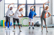 © LIGHTFIELD STUDIOS - happy multiethnic senior sportspeople synchronous exercising at sports hall
