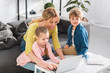 © LIGHTFIELD STUDIOS - happy mother with adorable smiling children using laptop together at home