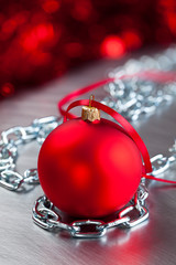Wall Mural - Christmas bauble and silver metal chains on steel background