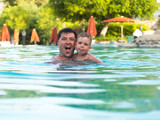 Fototapeta Na ścianę - Father and child swimming in the pool