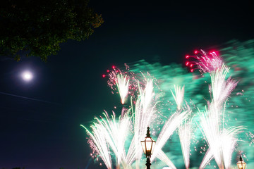 Holiday fireworks, light, tree and moon