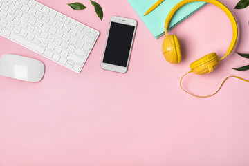 flat lay composition with smartphone, computer keyboard and headphones on color background. space fo