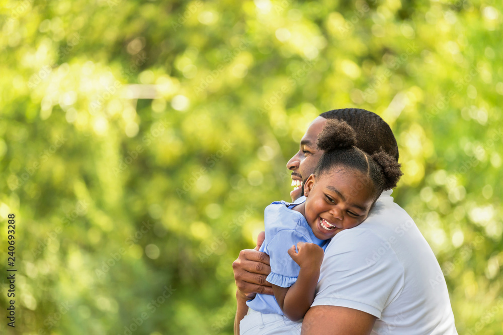 African American father hugging and holding his little girl. Stock ...