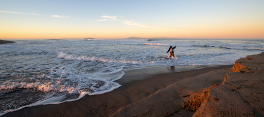 Fly fisherman at sunrise at Santa Clara river tidal inlet at McGrath State Park in Ventura California United States