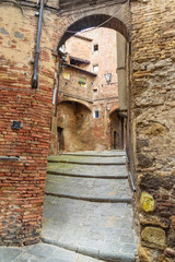 Wall Mural - Arch on medieval narrow street in Siena, Tuscany, Italy.