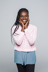 Wall Mural - Young african woman isolated on grey background