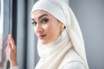 Wall Mural - portrait of beautiful young muslim woman smiling at camera