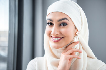 Wall Mural - portrait of beautiful happy young muslim woman smiling at camera