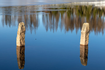 Two big stones in the middle of a lake in winter 