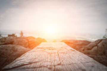 Wooden plank in front of the nature during the sunset.  Table background and spring time