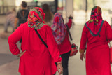 Fototapeta Uliczki - Muslim women  wait for friends to travel together