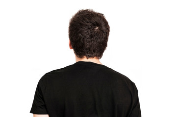 A teenager in a black shirt on a white background turned back to the camera. The guy does not like to take pictures, the teenager has complex character