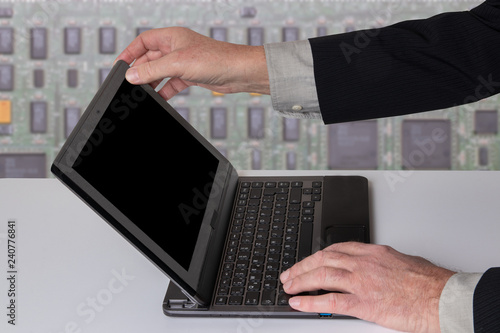 Fotografía Hands of a unrecognizeable businessman working with a modern portable computer on a white table
