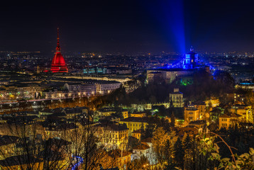 Wall Mural - Scenic night cityscape of Turin with the Mole Antonelliana and Monte dei Cappuccini lighted in red and blue, Italy 