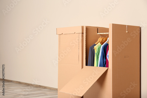 Wardrobe Boxes With Clothes Against Color Wall Indoors Space For