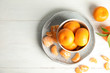 Flat lay composition with ripe tangerines on white wooden background. Space for text
