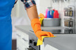 © New Africa - Man cleaning kitchen counter with rag, closeup