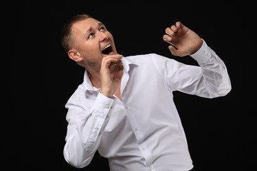 Wall Mural - Man having panic attack on dark background