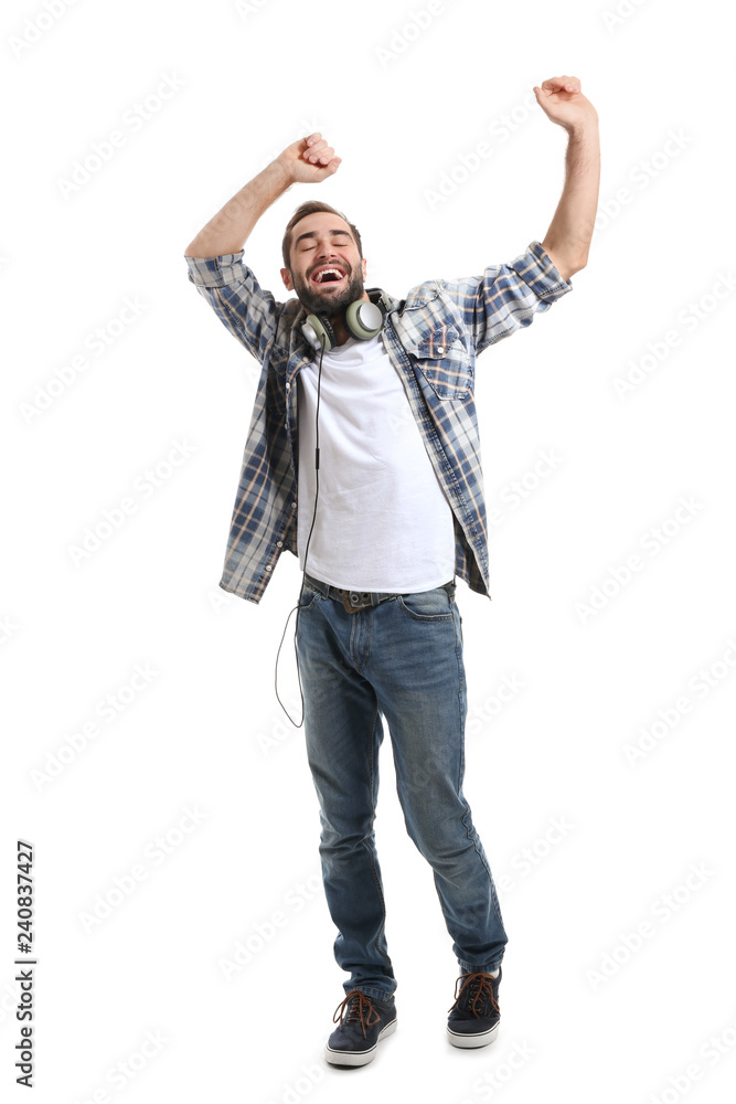 Handsome young man dancing on white background