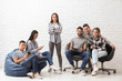 © Pixel-Shot - Team of young people near brick wall in office