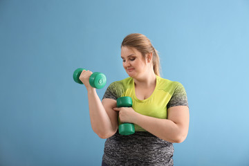 Wall Mural - Beautiful sporty plus size girl on color background. Concept of body positivity