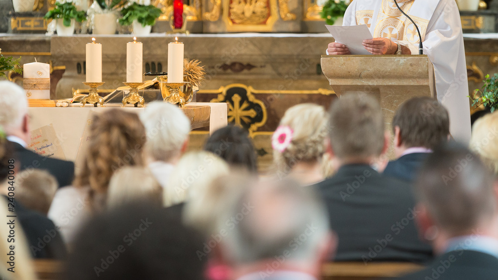 People with preacher are listen and Pray in a catholic church - obrazy, fototapety, plakaty 