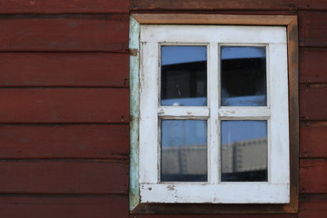 Old white window, red wood wall. 