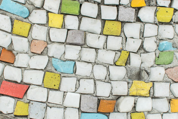 Background from a multi-colored mosaic on a wall.