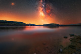 Fototapeta Niebo - Milky way galaxy on the lake. Night landscape 