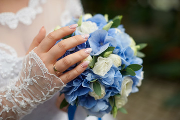 Wall Mural - bride holds in her hand a beautiful wedding bouquet of roses