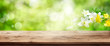 Green spring background with wooden table