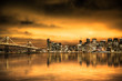 © littleny - View of San Francisco skyline under golden sunset sky with lights and Bay Bridge