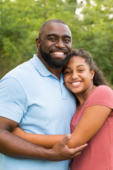 Wall Mural - Father and his daughter laughing and playing at the park.