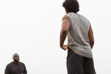 Wall Mural - American Football coach training a young athlete.