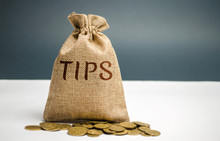 Money Bag With The Word Tips. Award For Good Service In The Cafe / Restaurant. A Gratuity Is A Sum Of Money Customarily Given By A Client Or Customer To A Service Worker In Addition To The Basic Price